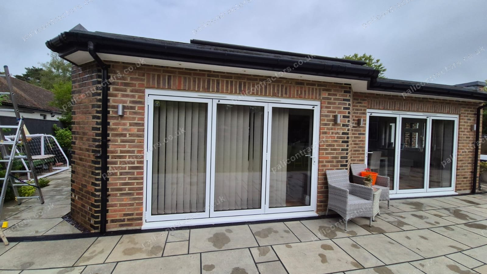 Modern rear extension with patio by Pali Contractors